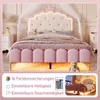 A princess-themed bed with a crown-shaped headboard, LED lighting, and decorative pillows in a bedroom setting. Podgląd zdjęcia produktu