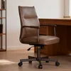 A brown leather office chair is shown in a well-lit room with a wooden desk and bookshelf in the background. Náhľad obrázku produktu