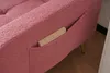 A close-up view of a pink sofa with a small wooden piece in a side pocket. Produktbild-Vorschau