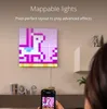 A person is holding a smartphone displaying a pixelated unicorn image, mirroring a larger pixelated unicorn displayed on LED panels mounted on a wall. The scene suggests a smart home lighting setup. Náhľad obrázku produktu