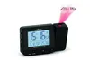 A black digital alarm clock with a projection feature, displaying the time and date on its screen and projecting the time onto a surface. Produktbild-Vorschau