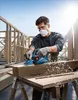 A man is using a Bosch power planer on a piece of wood at a construction site. Podgląd zdjęcia produktu