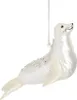 A white seal ornament hanging from a silver chain against a white background.
