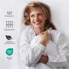 A woman lying in bed, holding a pillow, with product feature icons on the left. Produktbild-Vorschau