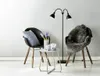 A modern living room scene with two chairs, a floor lamp, and a side table. Náhled obrázku produktu