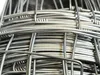 A close-up view of a roll of wire fencing, showing the woven pattern of the metal strands. Produktbild-Vorschau
