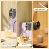 A collage of three images showing a portable electric kettle being used to pour water into a glass, a teacup, and a baby bottle. Produktbild-Vorschau
