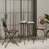 A bistro set with a mosaic table and two chairs on a patio. Anteprima dell’immagine prodotto