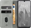A gray flip cover wallet case for a smartphone, with cards and cash inserted. Produktbild-Vorschau