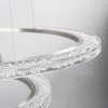 Close-up of a modern, circular pendant light fixture with a brushed nickel finish and crystal accents. Anteprima dell’immagine prodotto