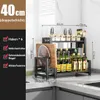 A kitchen counter with a multi-tiered organizer holding various bottles, jars, and a cutting board. Produktbild-Vorschau