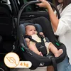 A baby is sitting in a car seat, held by a person. Náhled obrázku produktu