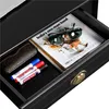A close-up view of an open drawer containing a magazine, sunglasses, a glasses case, and markers. Produktbild-Vorschau