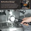 A hand holding a bottomless portafilter near an espresso machine. Náhled obrázku produktu