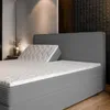 A close-up view of a bed with a headboard and mattress. Produktbild-Vorschau