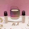 A karaoke set with a speaker and two microphones, decorated with confetti and streamers against a sparkly pink background. Anteprima dell’immagine prodotto