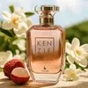 A perfume bottle is displayed with lychee fruits and white flowers in the background. Náhled obrázku produktu