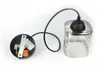 A pendant light fixture with a silver glass shade and a black cord and ceiling mount. Produktbild-Vorschau