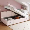 A pink upholstered bed with its storage compartment open, revealing stored items. The room has pink walls and a slanted ceiling, with decorative stars and a moon light fixture. Anteprima dell’immagine prodotto