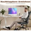 A man is sitting in a black office chair at a white standing desk with a computer on it. Voir les images du produit