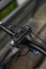 A close-up shot of a black bicycle headlight mounted on the handlebars of a bicycle. Anteprima dell’immagine prodotto