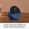 An Amazon Echo Spot smart speaker is shown on a wooden table next to a glass of water. Produktbild-Vorschau