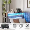 A bed with a headboard featuring integrated lighting and charging ports, decorated with plants and accessories. Anteprima dell’immagine prodotto