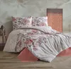 A bed with floral patterned bedding in a room setting. Produktbild-Vorschau