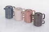 Four teapots are lined up on a white reflective surface. Podgląd zdjęcia produktu