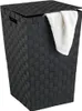 A black woven laundry basket with a lid and a white towel draped over the edge. Náhľad obrázku produktu