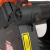 A close-up view of a power tool, focusing on the laser emitter and warning labels. Náhled obrázku produktu