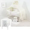 A nursery room setting with a crib and accessories. Voir les images du produit