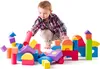 A young boy is playing with colorful foam blocks. Voir les images du produit