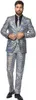 A man wearing a silver disco suit with a black shirt and tie.
