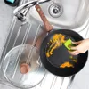 A person is cleaning a frying pan in a kitchen sink. Náhled obrázku produktu