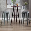 Two gray metal bar stools flank a dark wood high-top table with a bottle and glasses on top, set against a gray textured wall and a white shelf. Náhľad obrázku produktu