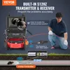 A man is using a pipe inspection camera system. The image highlights the built-in transmitter and receiver feature. Podgląd zdjęcia produktu