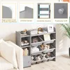 A grey, multi-tiered storage unit for children's toys and books, placed next to a cream-colored sofa. The image includes close-up insets highlighting product features. Podgląd zdjęcia produktu