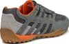 A side view of a single grey Geox sneaker with orange accents and a brown sole. Produktbild-Vorschau