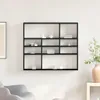 A black wall shelf with various decorative items on it, mounted on a white wall. Náhled obrázku produktu