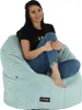 A woman is sitting comfortably on a light blue beanbag chair. Náhľad obrázku produktu
