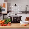 A kitchen counter with a food steamer, fresh vegetables, and a bowl. Náhled obrázku produktu