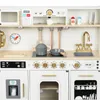 A detailed view of a wooden toy kitchen, showcasing various appliances and accessories. Produktbild-Vorschau