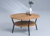 A round, two-tiered coffee table with a wood-grain finish and black metal legs, set against a light gray background with subtle light reflections. Produktbild-Vorschau