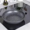 A frying pan is placed on a black induction stovetop. Náhled obrázku produktu