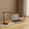 A desk setup with a laptop, a desk lamp, and a small plant. Podgląd zdjęcia produktu