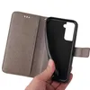 A hand holding a grey flip phone case open, revealing the black inner shell. Produktbild-Vorschau