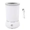 A white automatic dog paw cleaner with a gray rim and a USB charging cable on a white background. Voir les images du produit