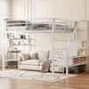 A white metal loft bed with a sofa underneath, set up in a room with light-colored walls and wooden flooring. Náhled obrázku produktu