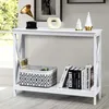 A white console table with decorative items and books on it, placed near a window. Podgląd zdjęcia produktu